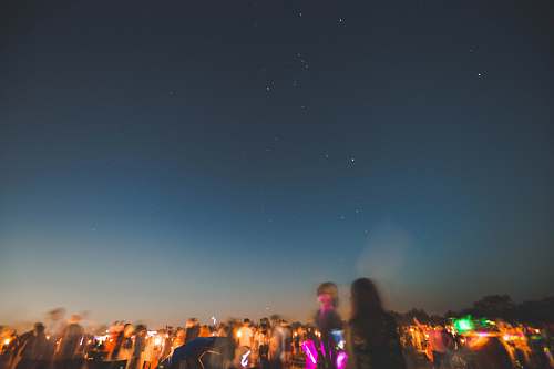 leisure activities people standing on land at night time crowd